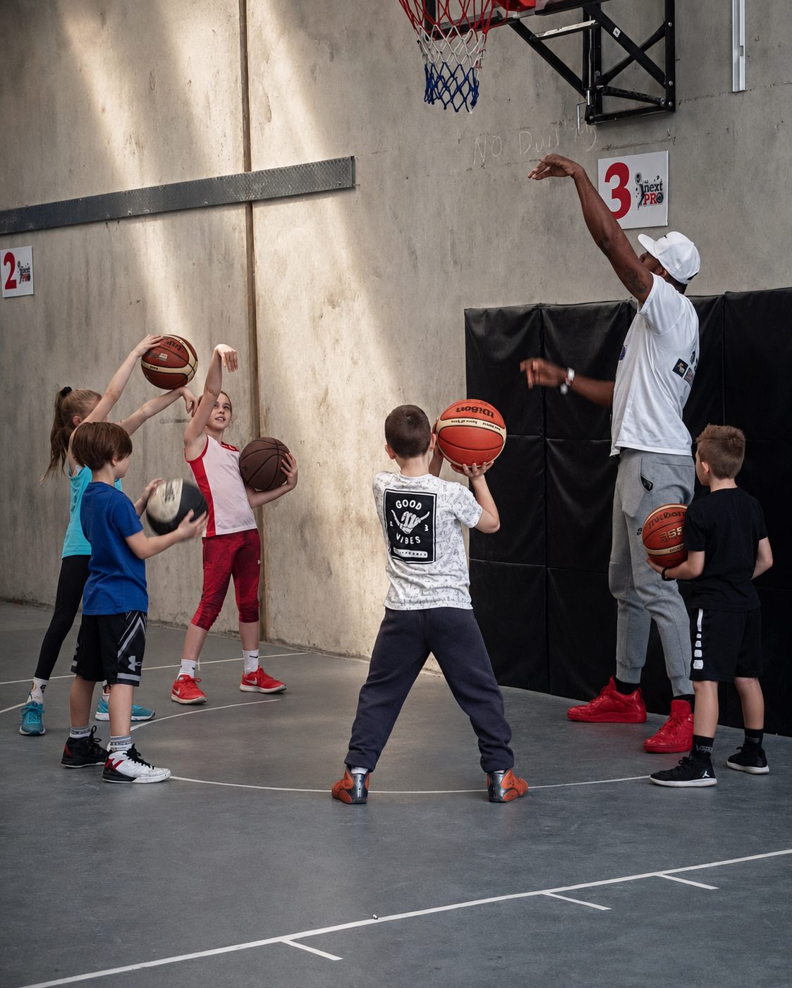 Academy session — kids running shooting drills with Coach Ivan