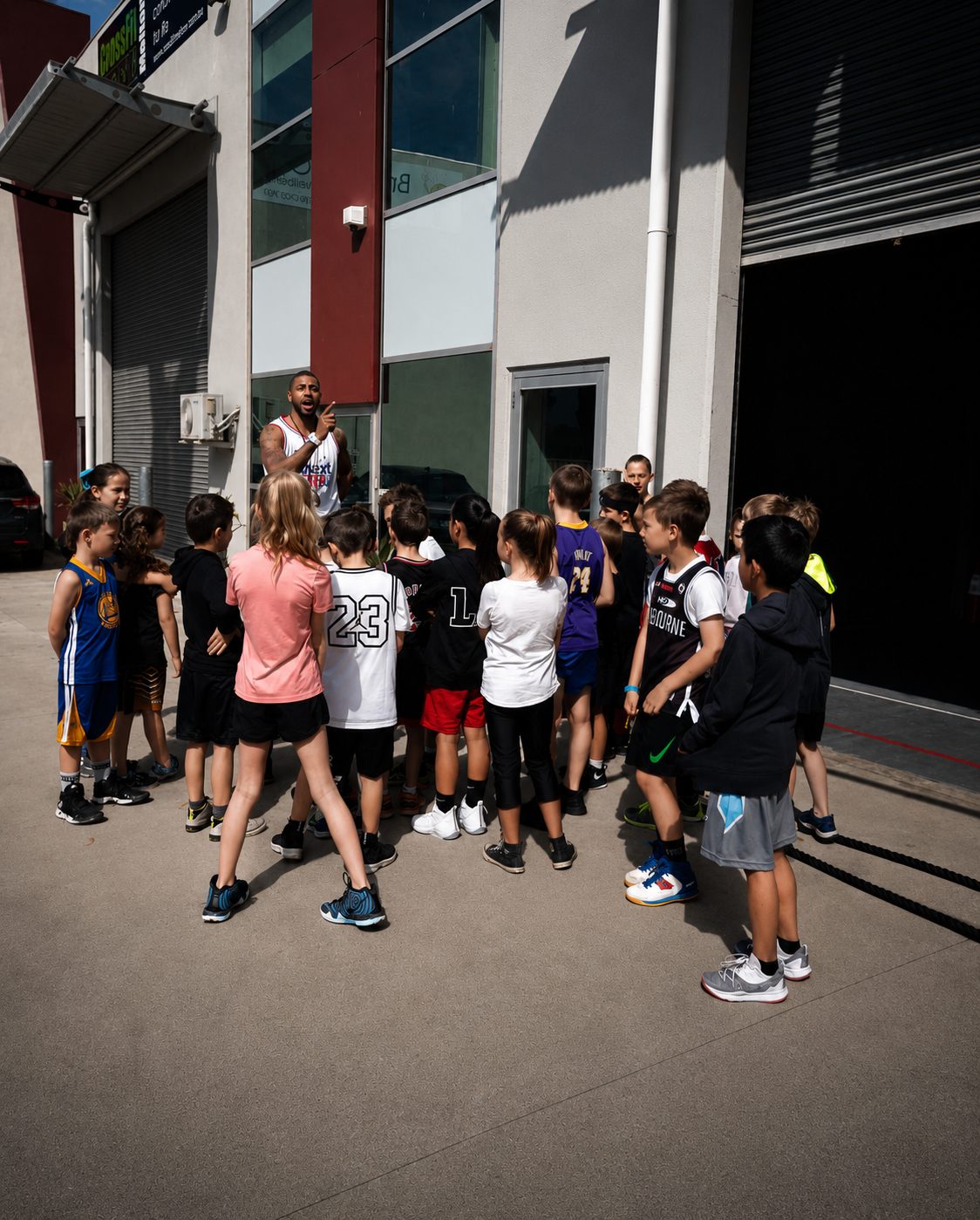 Ivan huddles the academy kids outside the facility